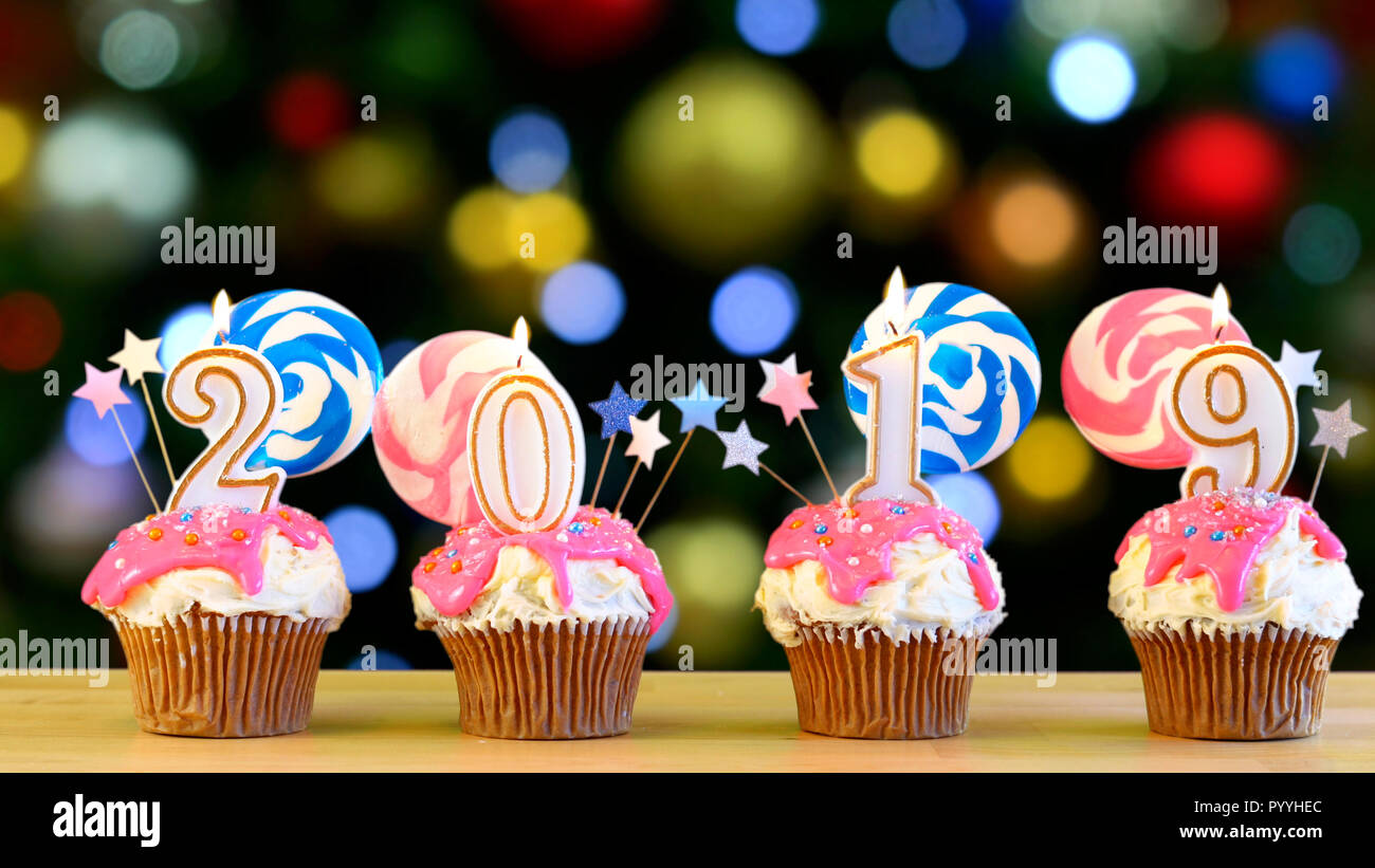 2019 Happy New Year’s candy land lollipop drip cupcakes against bokeh