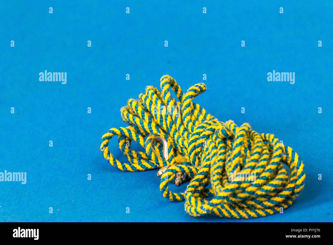 Yellow and blue rope on a blue background Stock Photo - Alamy