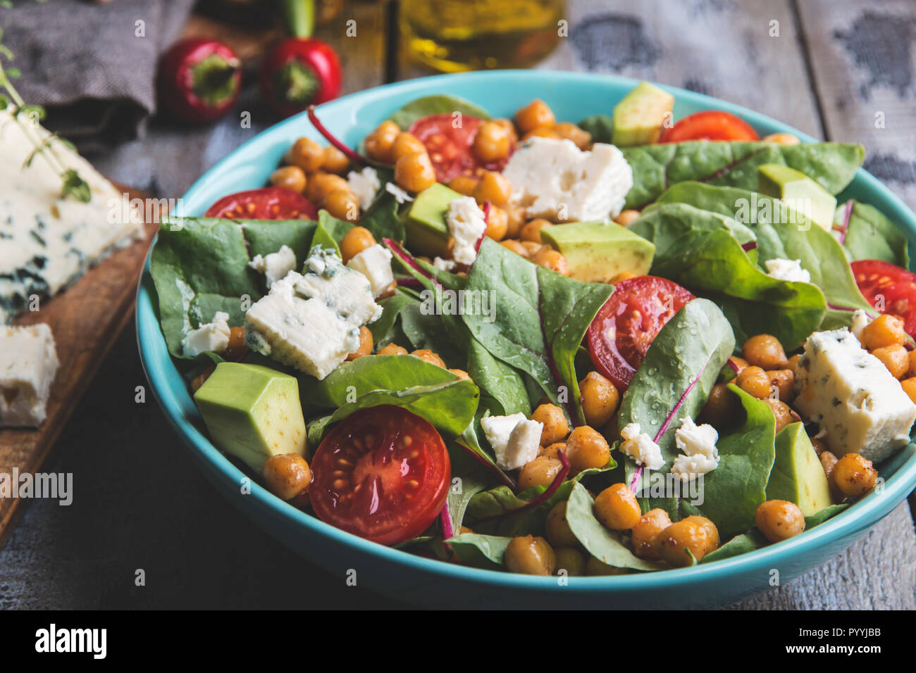 Healthy vegan salad with avocado ,beet leaves ,chickpea, broccoli ,tomato,blue cheese Stock Photo