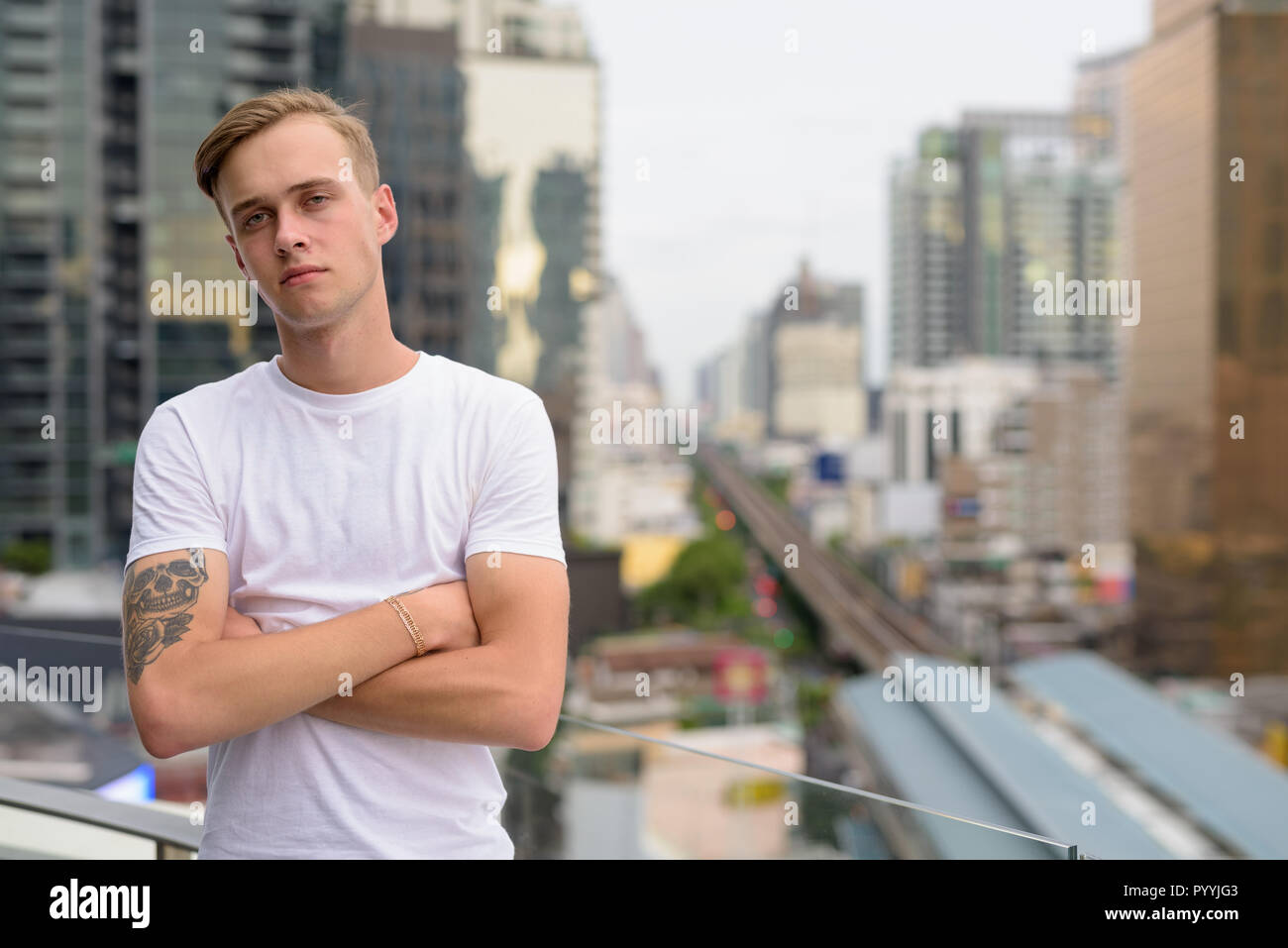 Young Handsome Man With Blond Hair Against View Of The City Stock