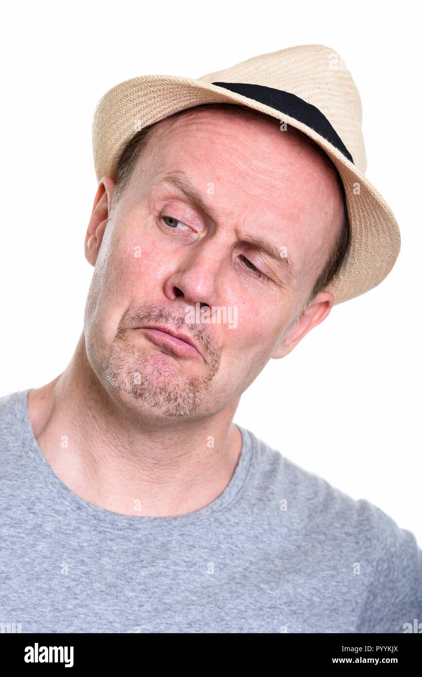 Face of mature man wearing hat while looking down and thinking Stock Photo