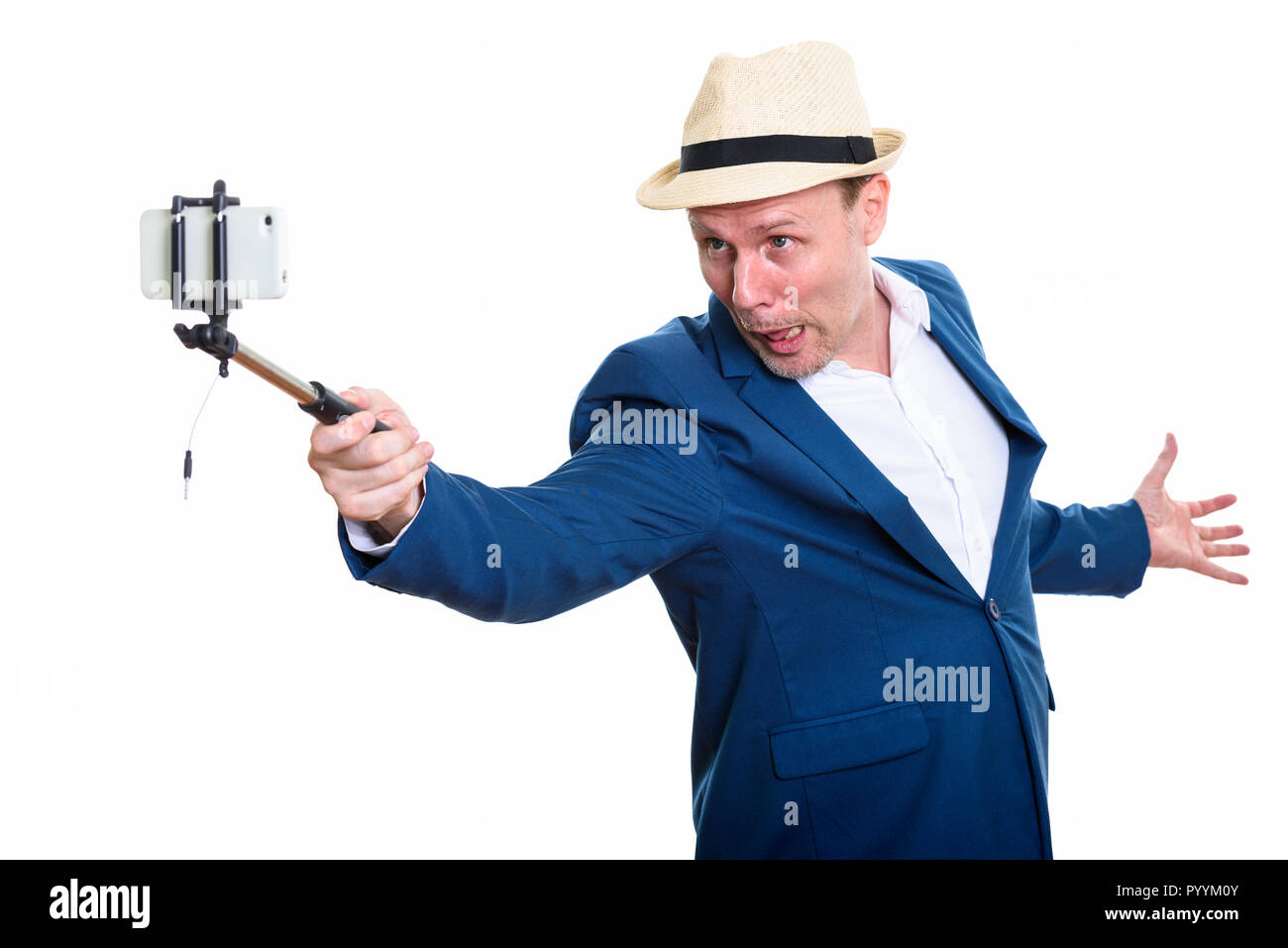 Mature businessman holding selfie stick and taking selfie pictur Stock