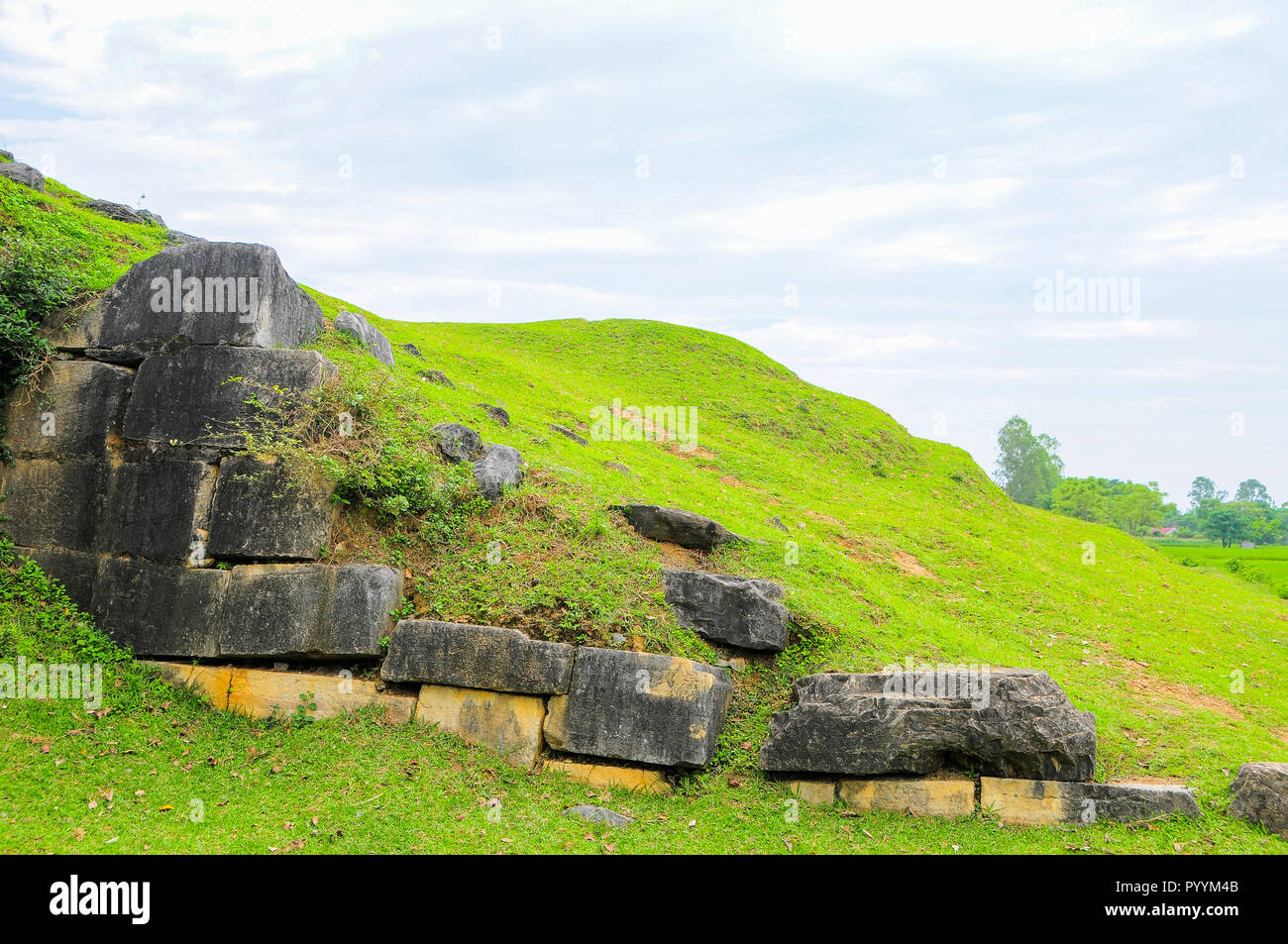 Massive stones and earthen ramparts form the north wall of the Ho Citadel, Thanh Hoa Province, Vietnam. The citadel became a UNESCO World Heritage Sit Stock Photo