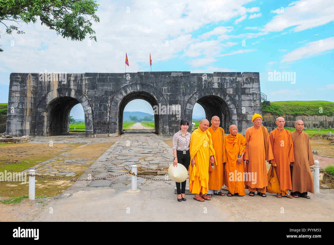 Ho Citadel, Thanh Hoa Province, Vietnam - May 9, 2014. Tour guide and monks at the south gate of the citadel, which became a UNESCO World Heritage Sit Stock Photo