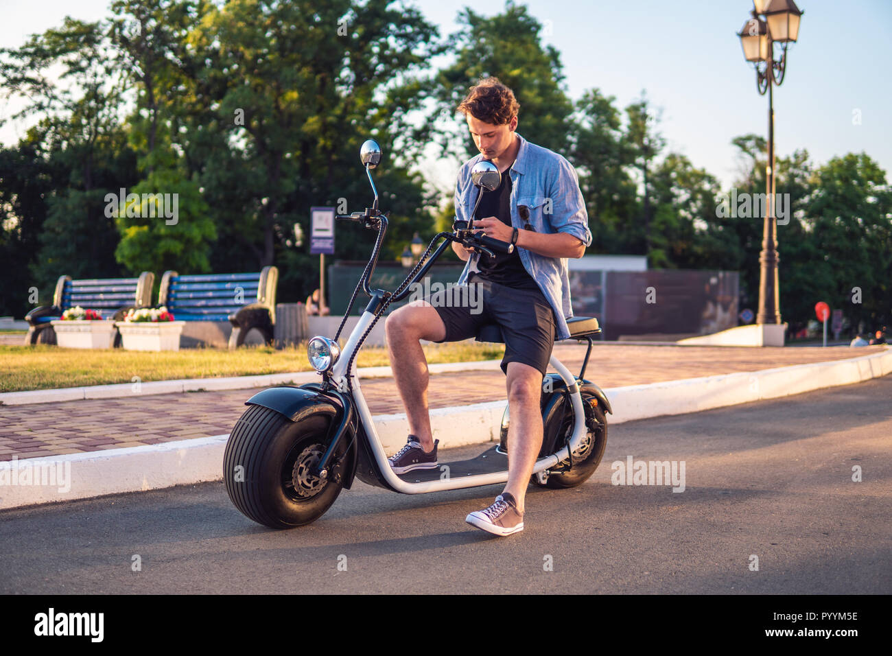Couple on electric scooter hi-res stock photography and images - Alamy
