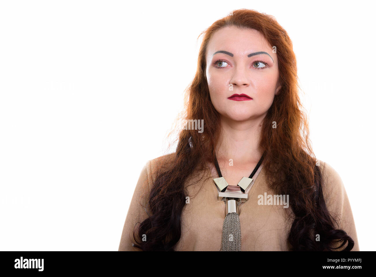 Studio shot of woman thinking while looking at distance Stock Photo