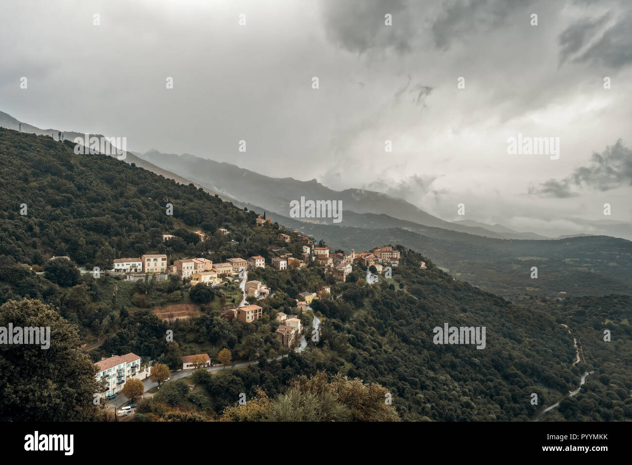 Dark stormy skies over the mountain village of Belgodere in the Balagne region of Corsica Stock Photo
