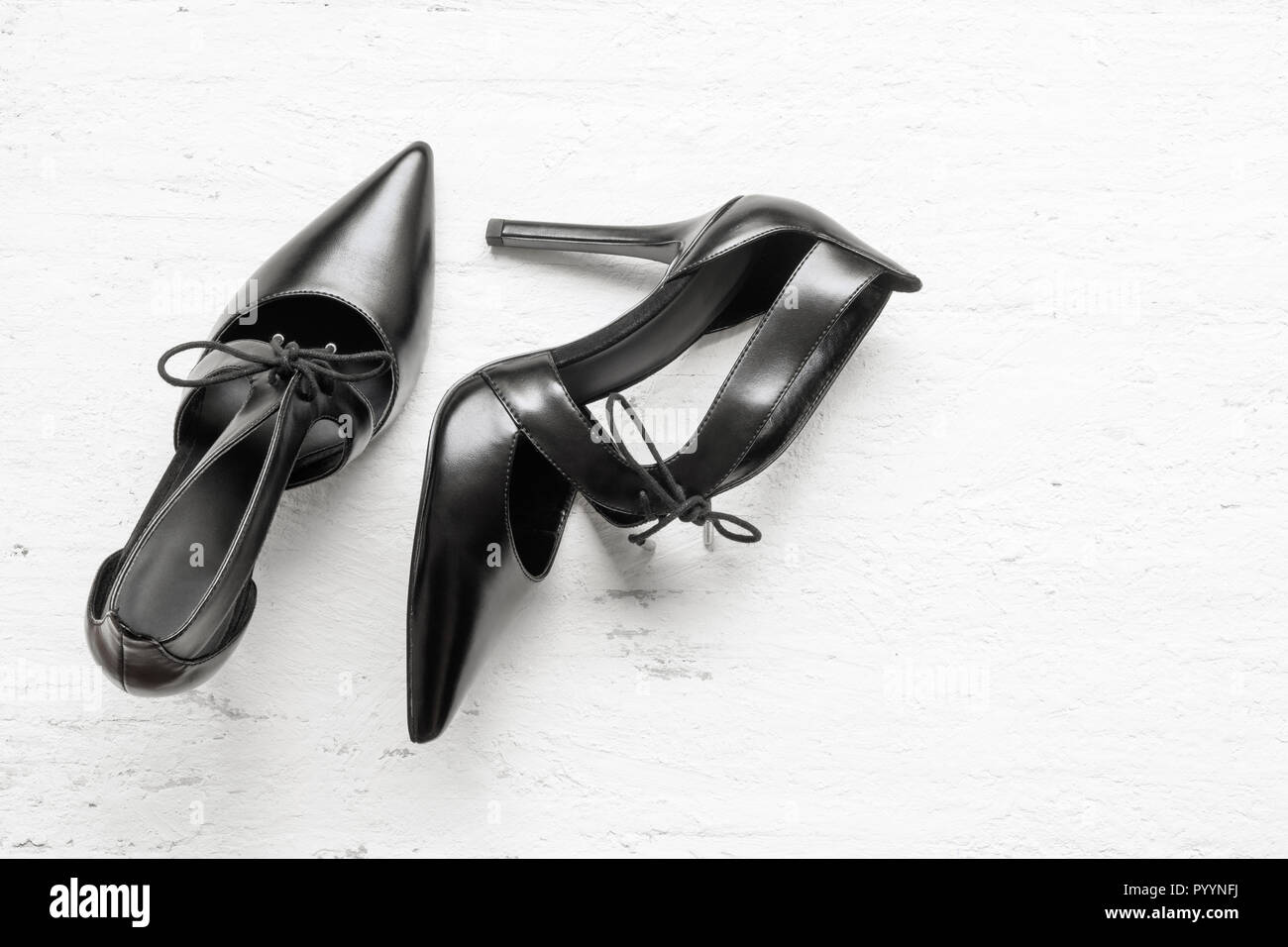 Flat lay black high heels on grunge white wood Stock Photo - Alamy