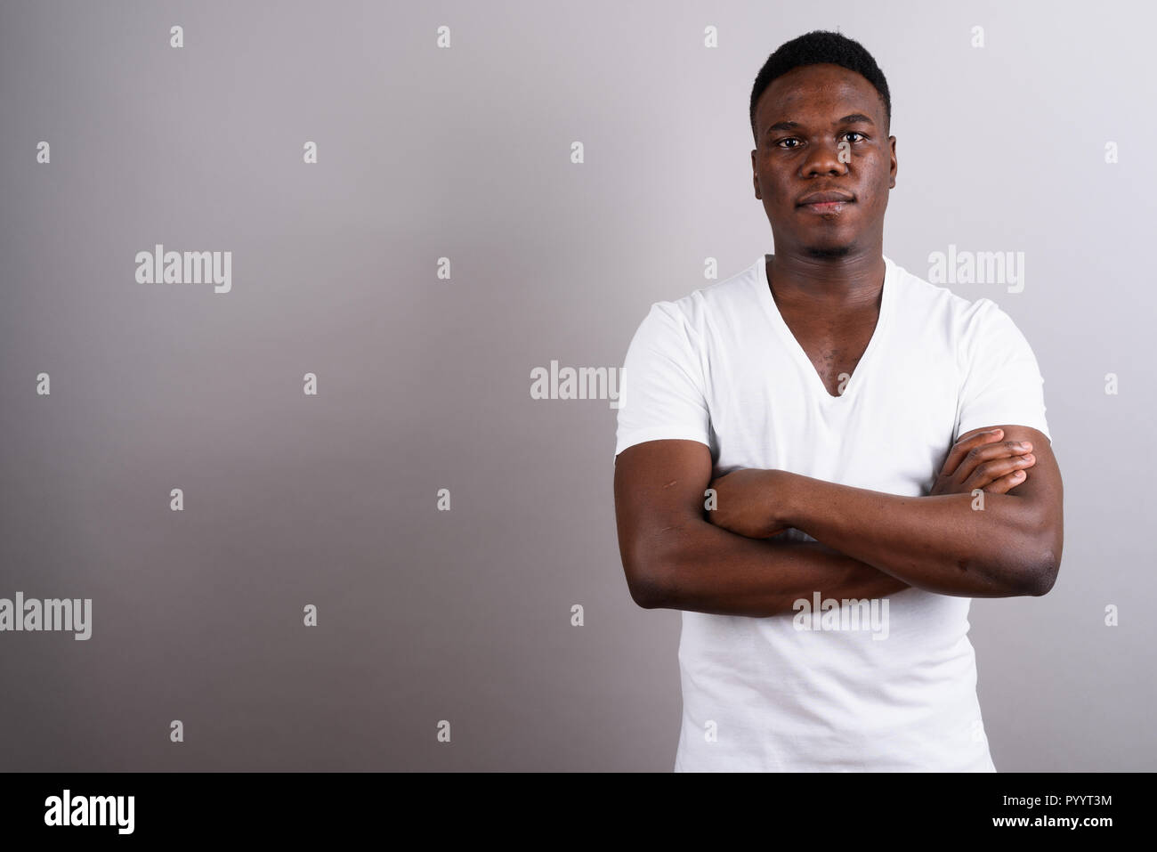Portrait of young African man against white background Stock Photo - Alamy