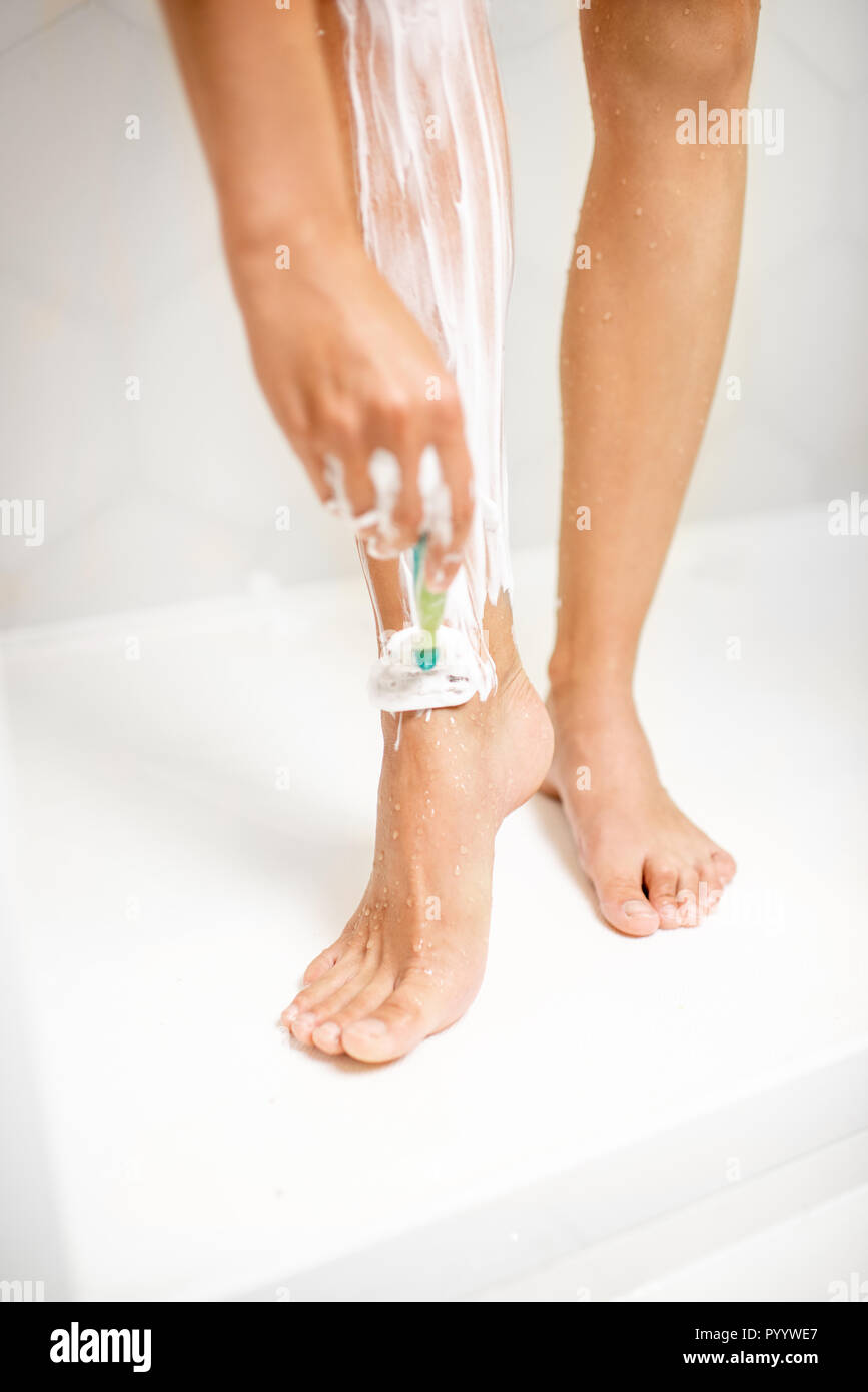 Woman shaving legs in bathroom hires stock photography and images Alamy