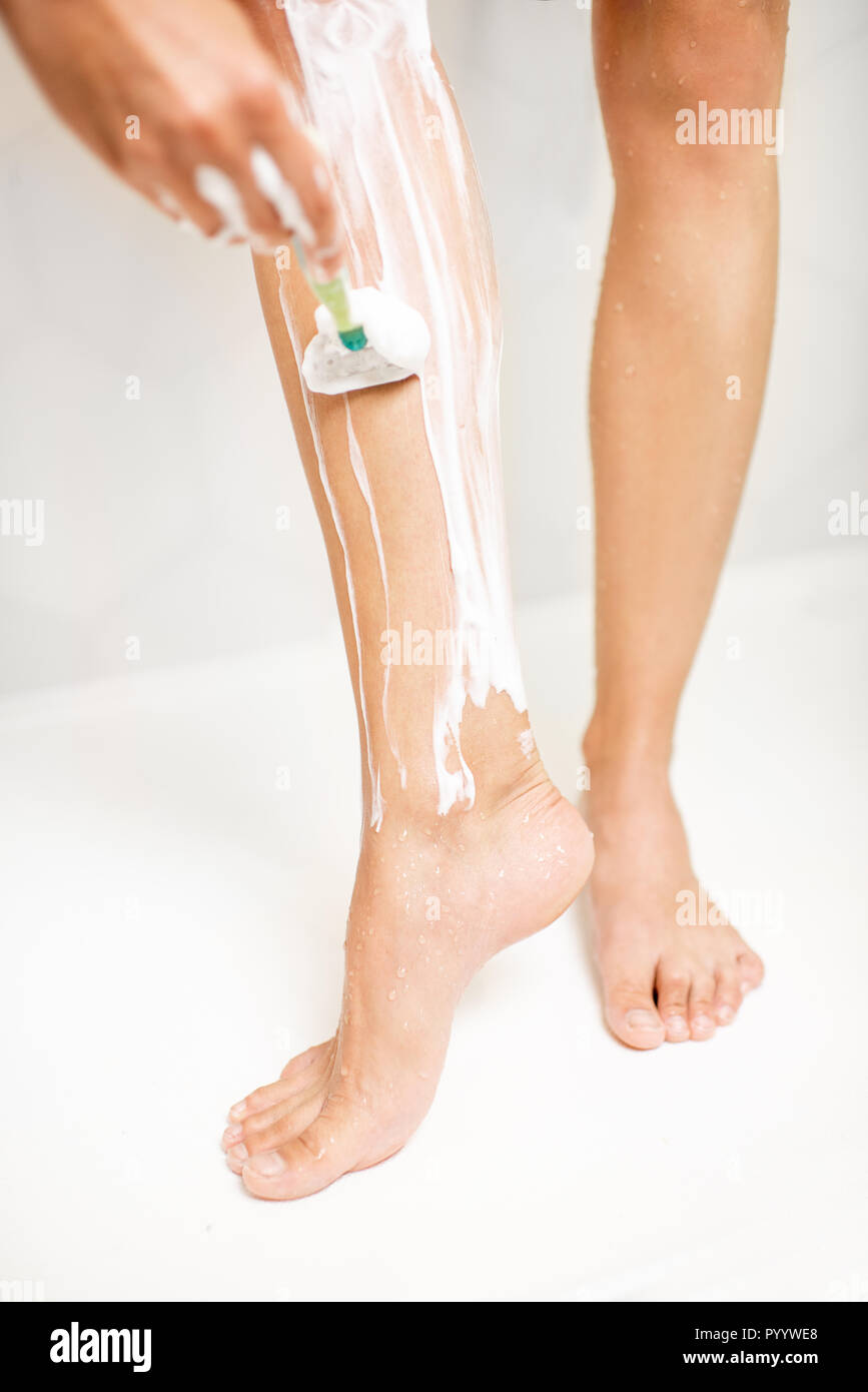 Woman Shaving Legs In Bathroom High Resolution Stock Photography and