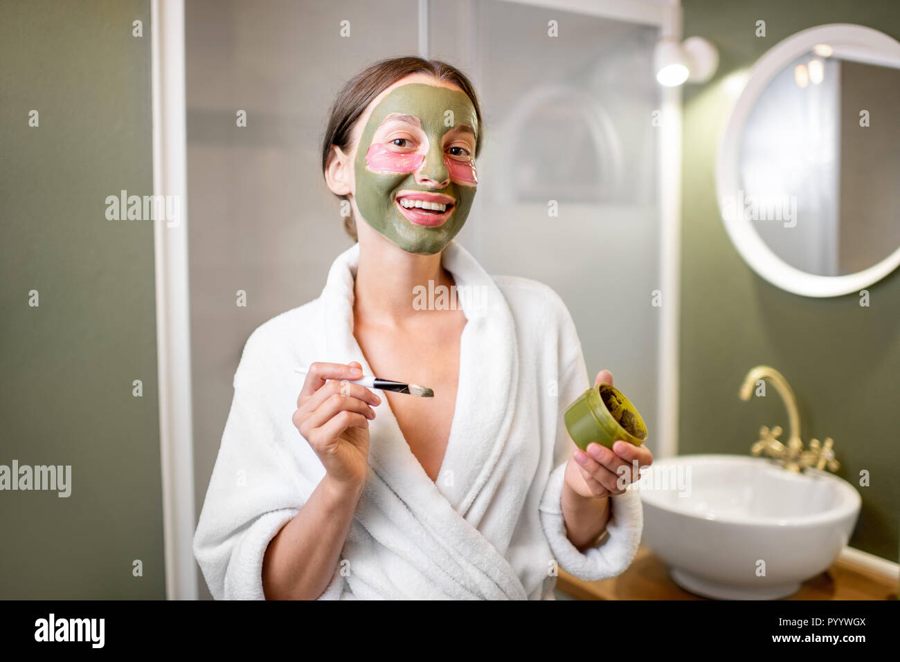 Beautiful woman taking care of herself with facial mask and patches