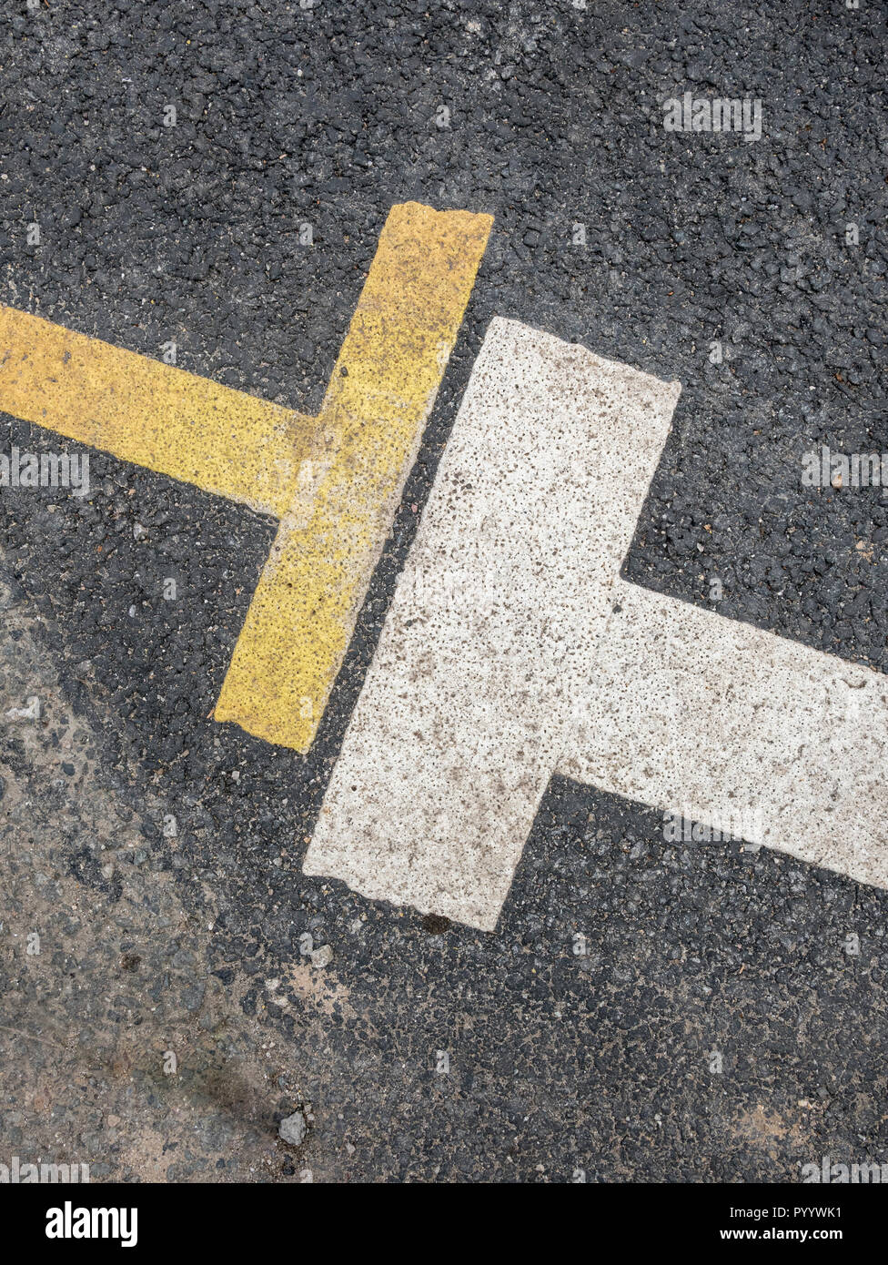 Road abstract. White and yellow parking zone restriction lines on