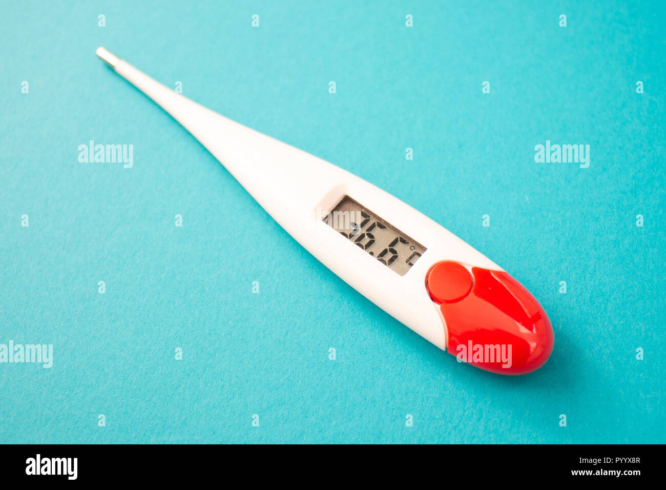 White digital clinical thermometer on blue background shows normal