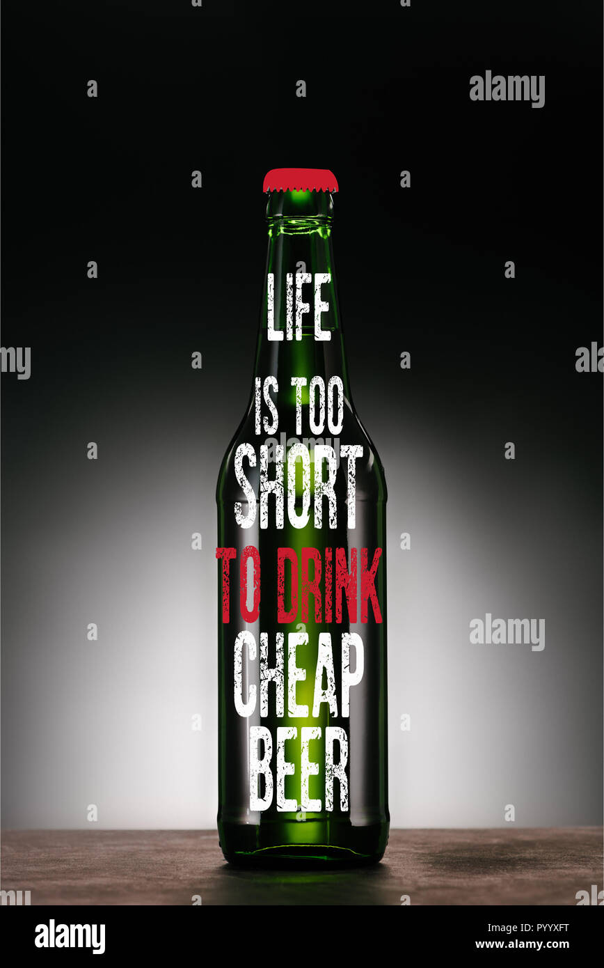 bottle of beer on dark grey background with 'life is too short to drink cheap beer' inspiration Stock Photo