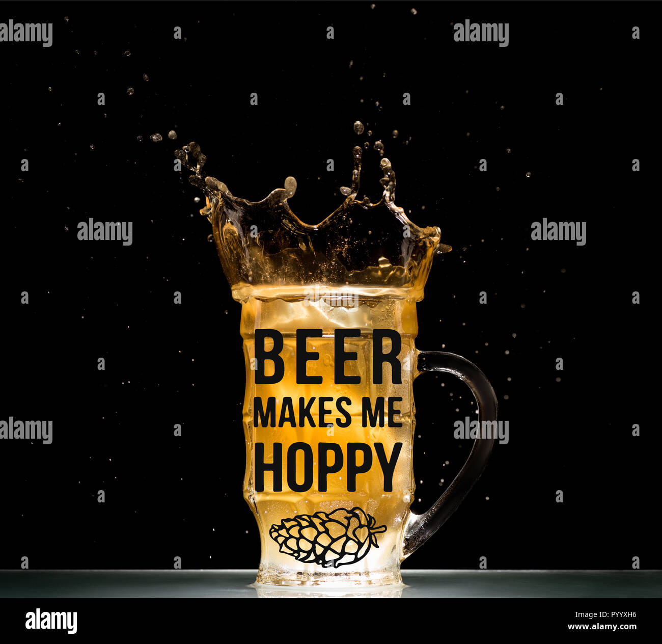 glass of light  beer with splashes at table on black background with 'beer makes me hoppy' lettering Stock Photo