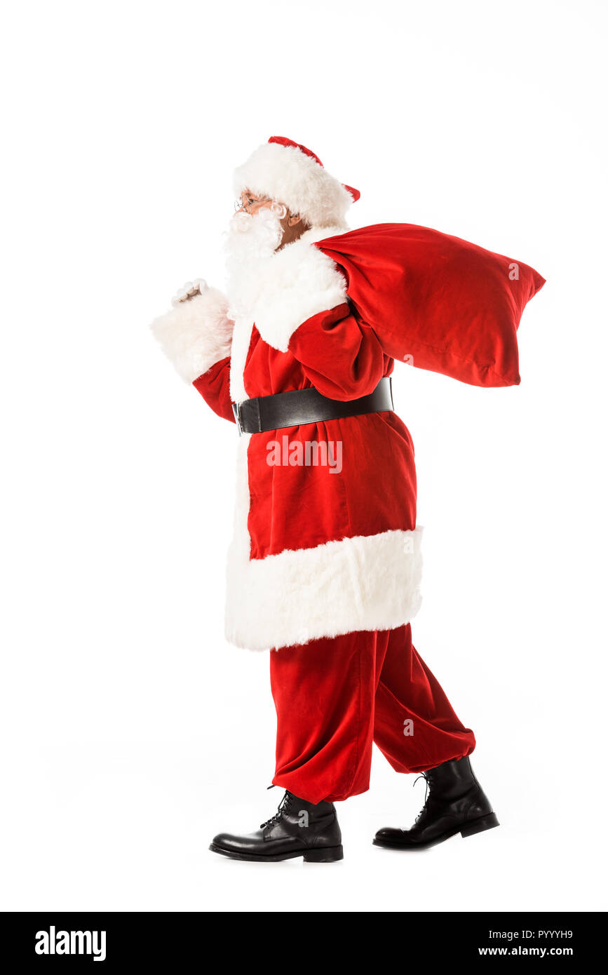 side view of santa claus walking with sack isolated on white Stock ...