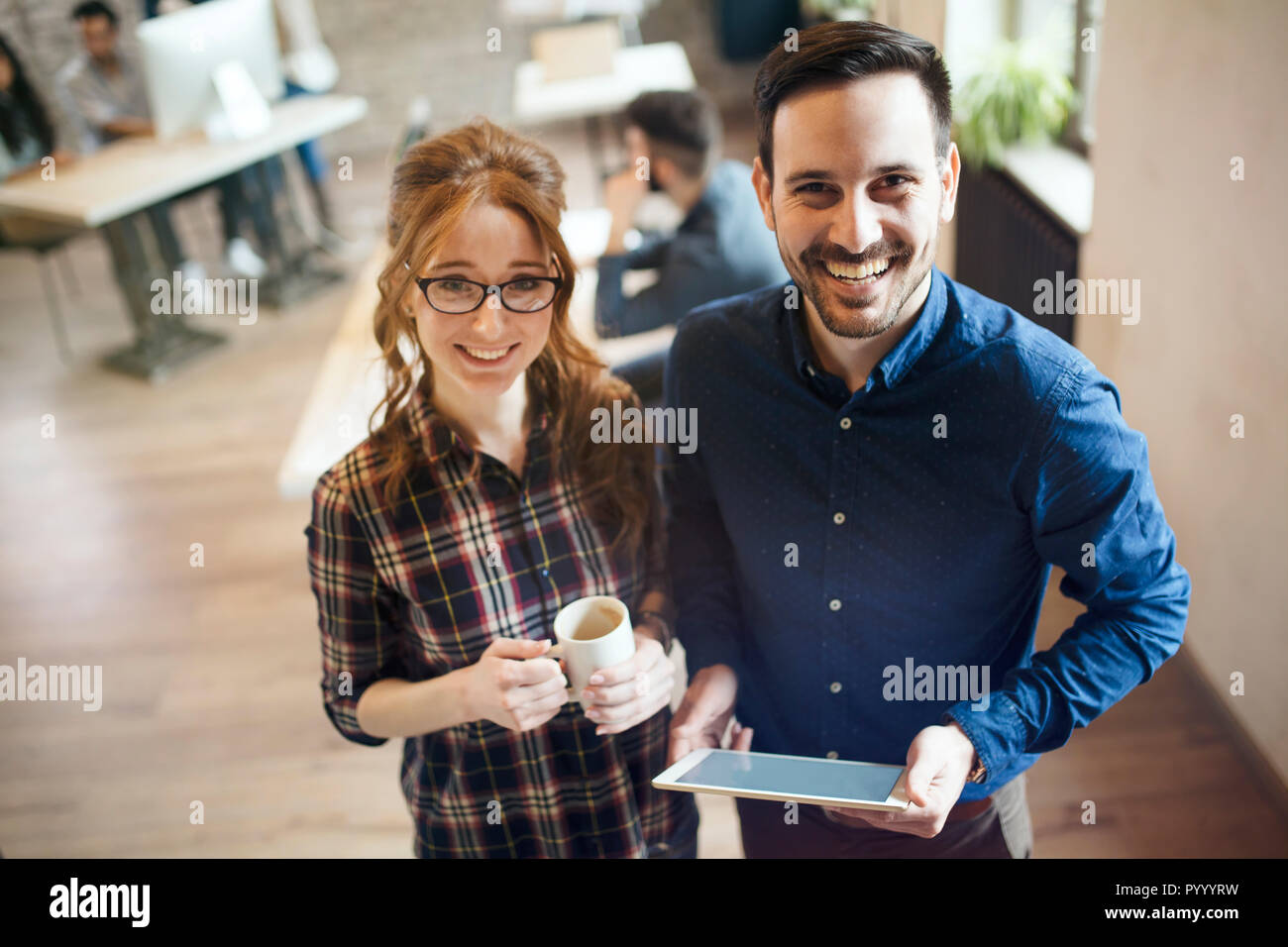 Picture of young designers posing in office Stock Photo