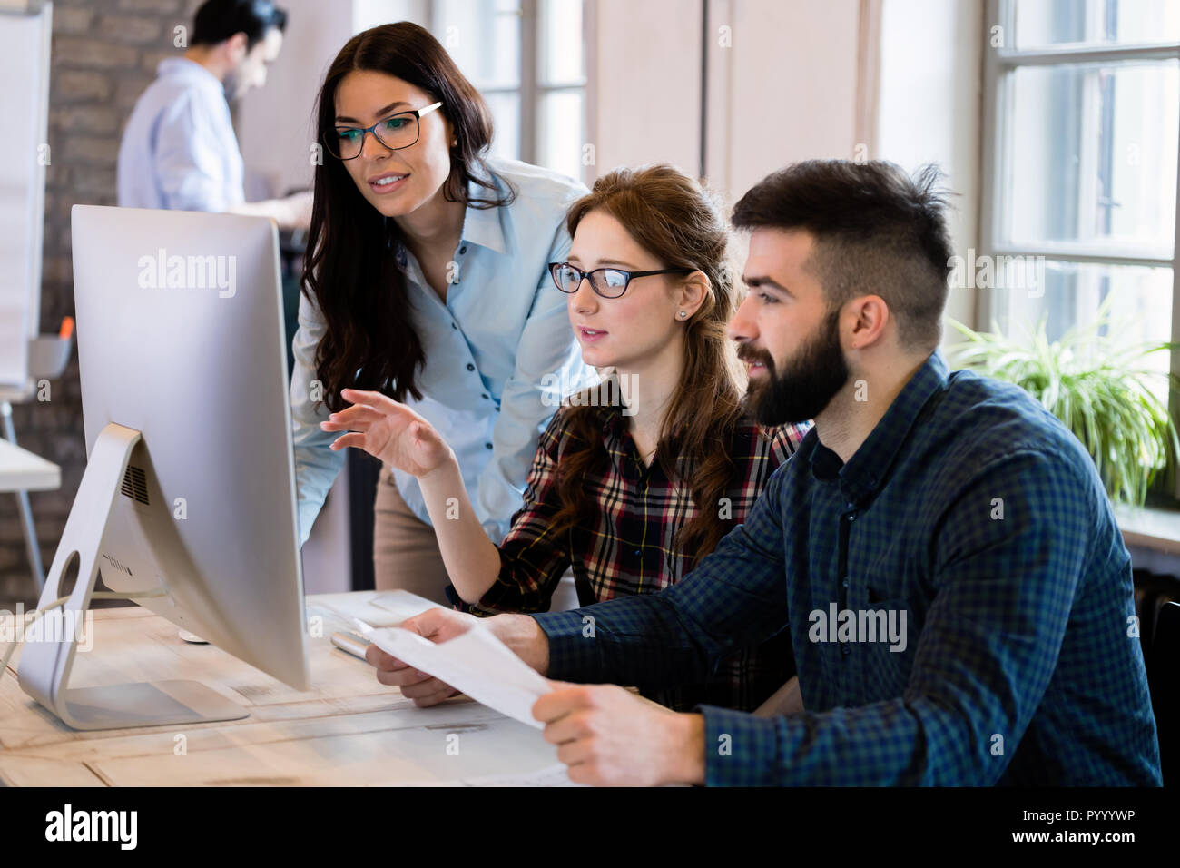 Young architects working on project in office Stock Photo