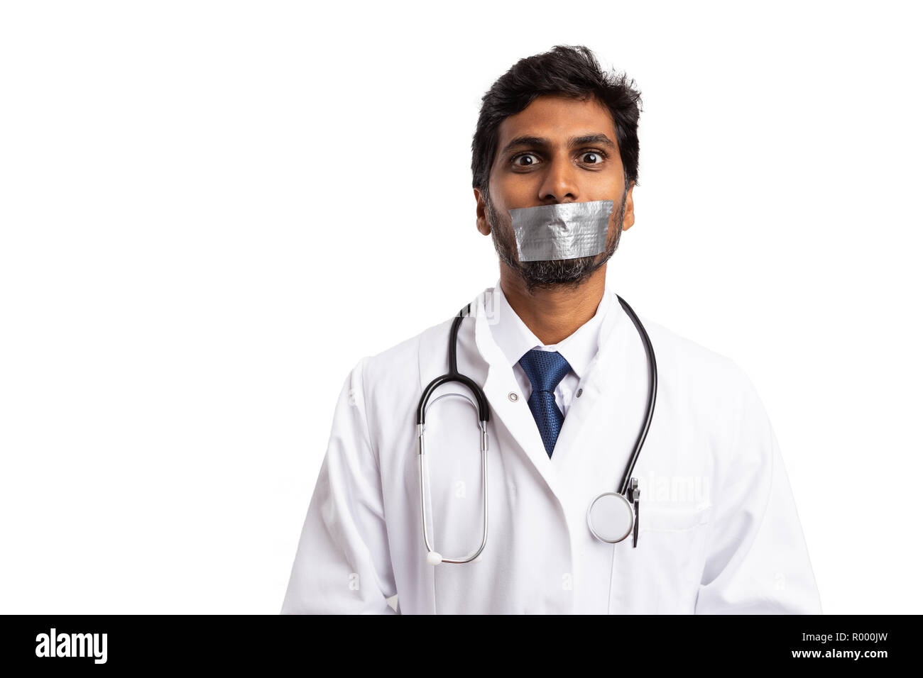 Indian doctor with duct taped mouth as professional secret concept isolated on white background Stock Photo