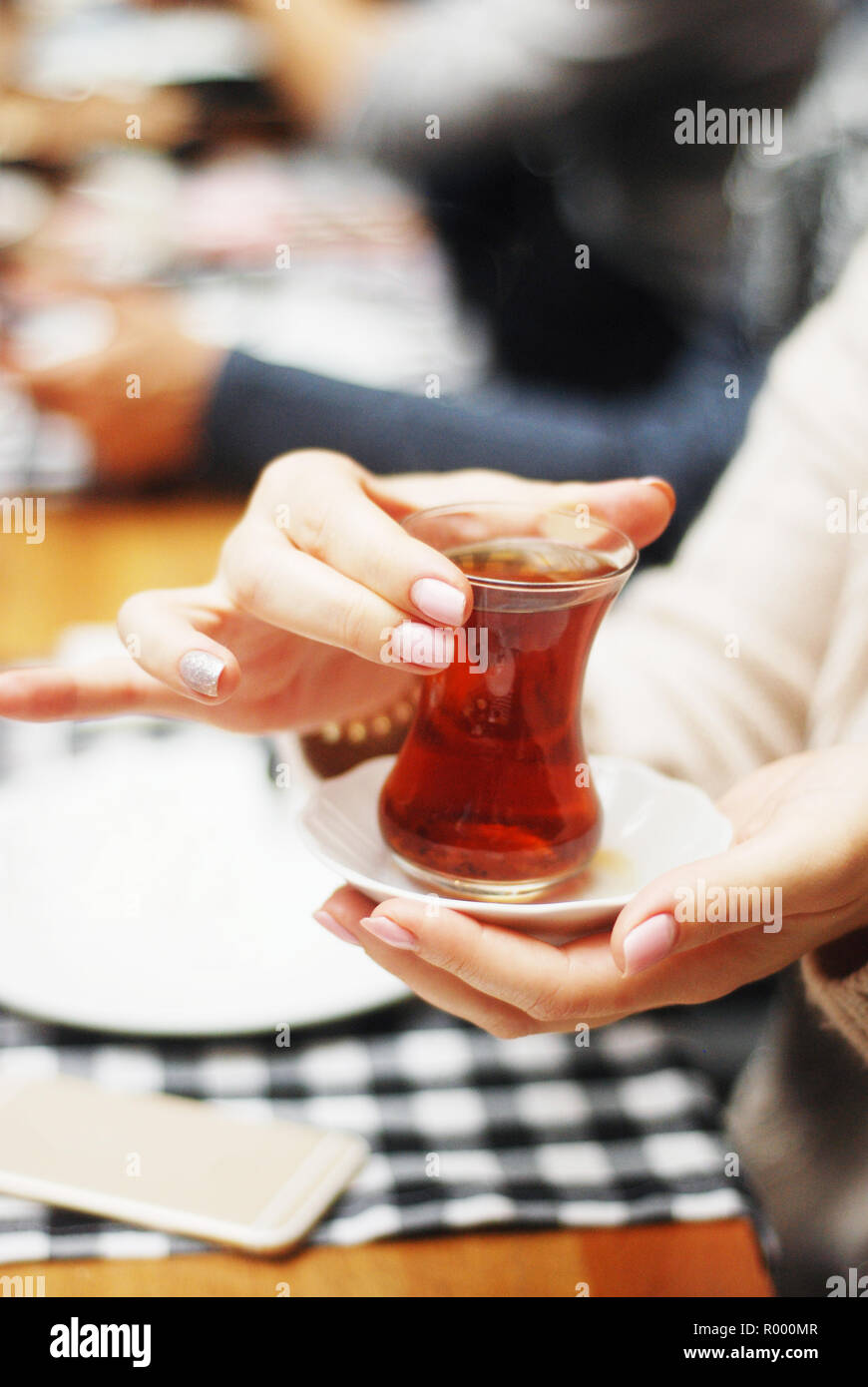 Drinking turkish tea in small glasses closeup Stock Photo