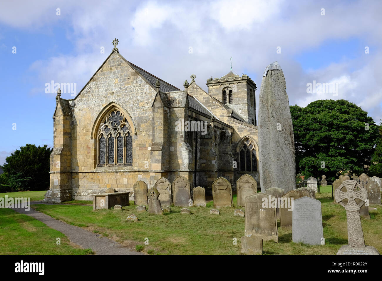 The prehistoric standing stone in the churchyard at Rudston, East Yorkshire Stock Photo