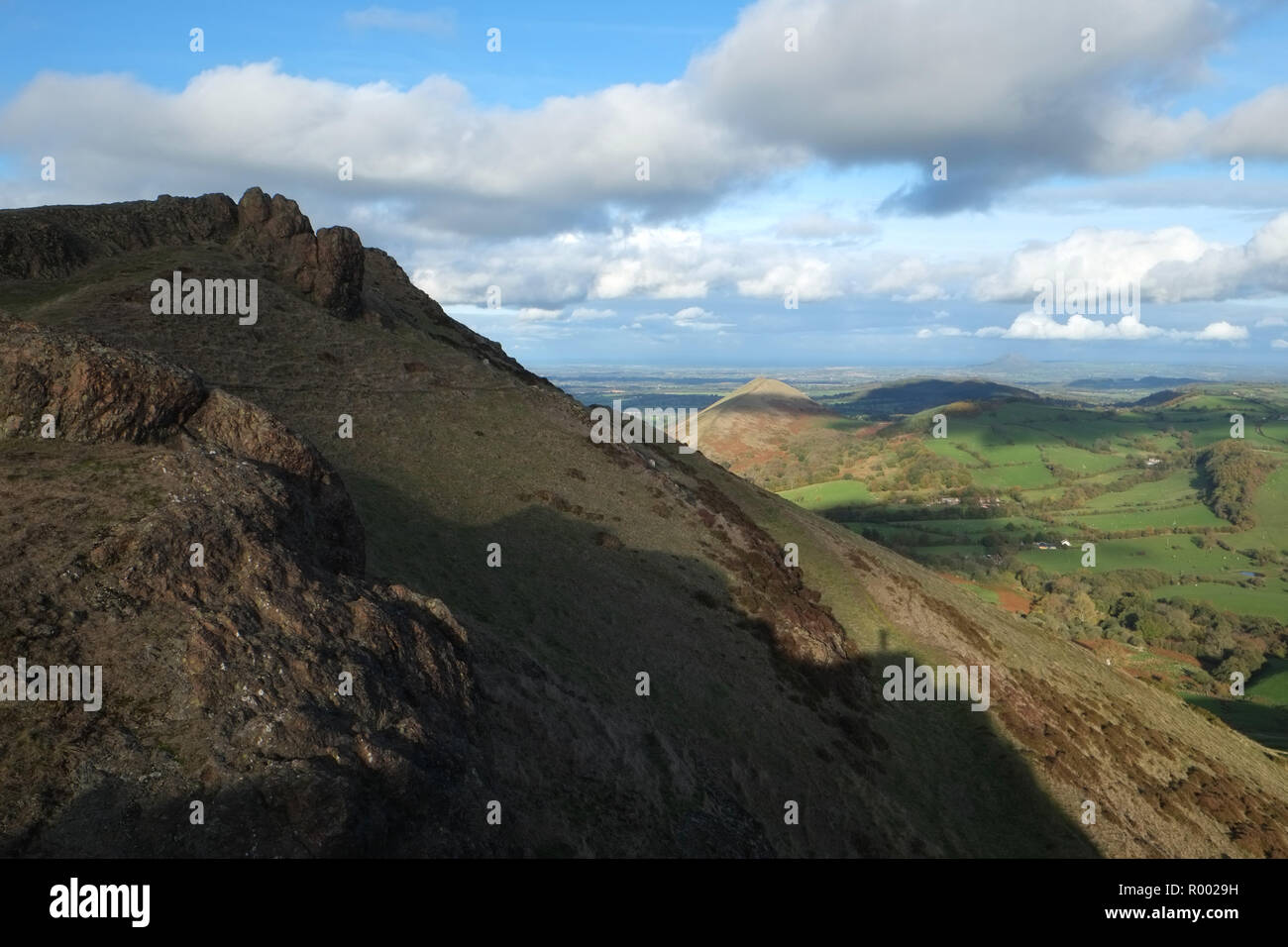 Caer Caradoc in the foreground, and The Lawley Hill in the distant centre, Church Stretton, Shropshire, UK. The shadow of the photographer can be seen lower right centre Stock Photo
