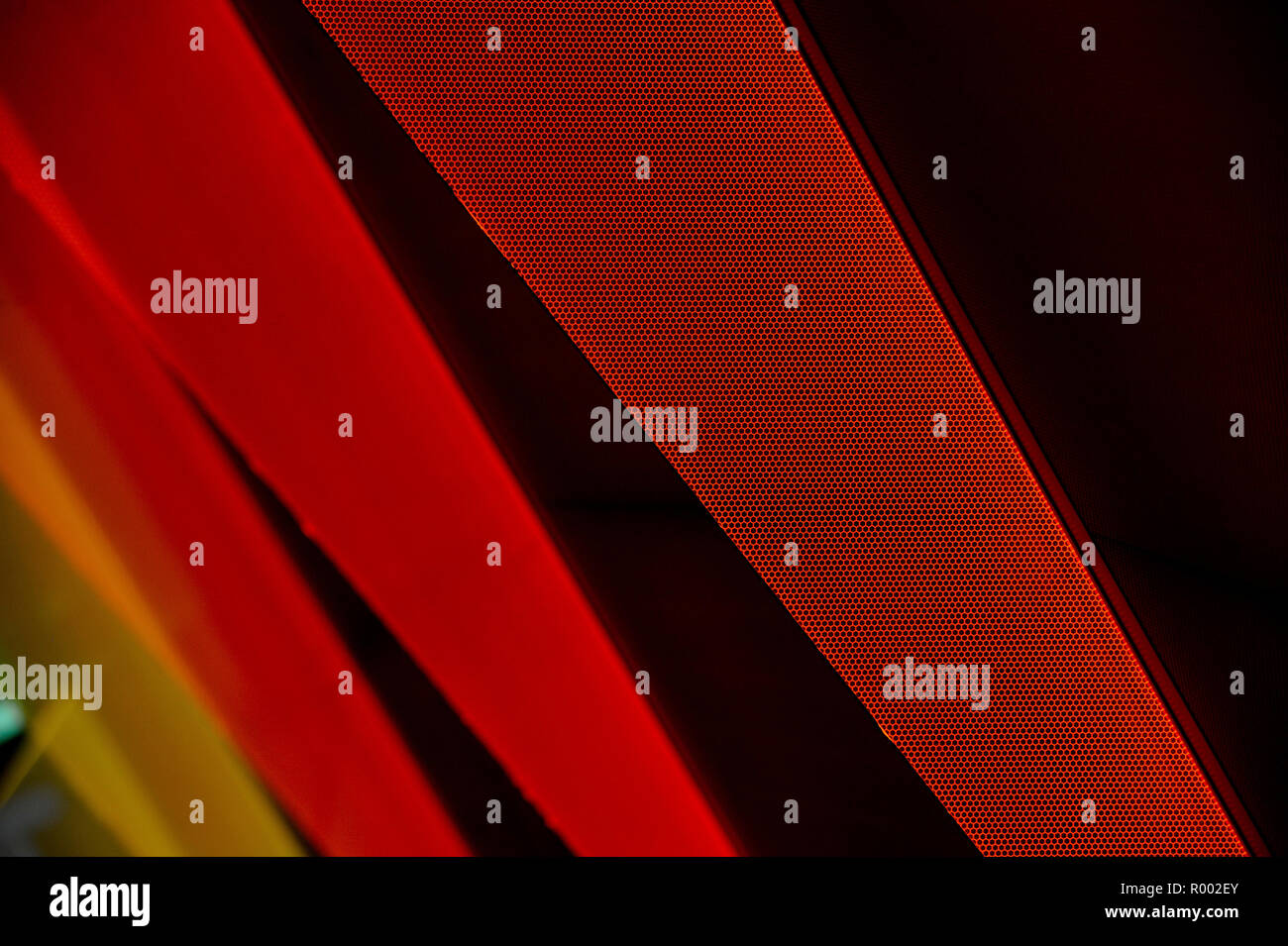 Red, orange and yellow triangular shapes on black background. Stock Photo