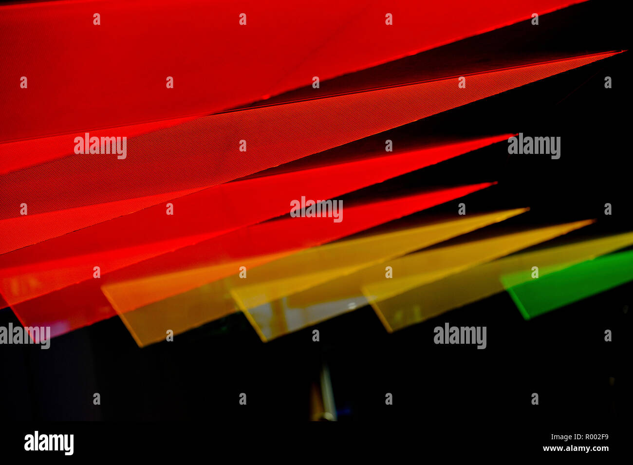 Red, orange and yellow triangular shapes on black background. Stock Photo