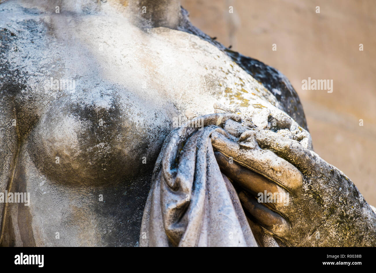 detail of a sculture  showing nude female holding cloth Stock Photo