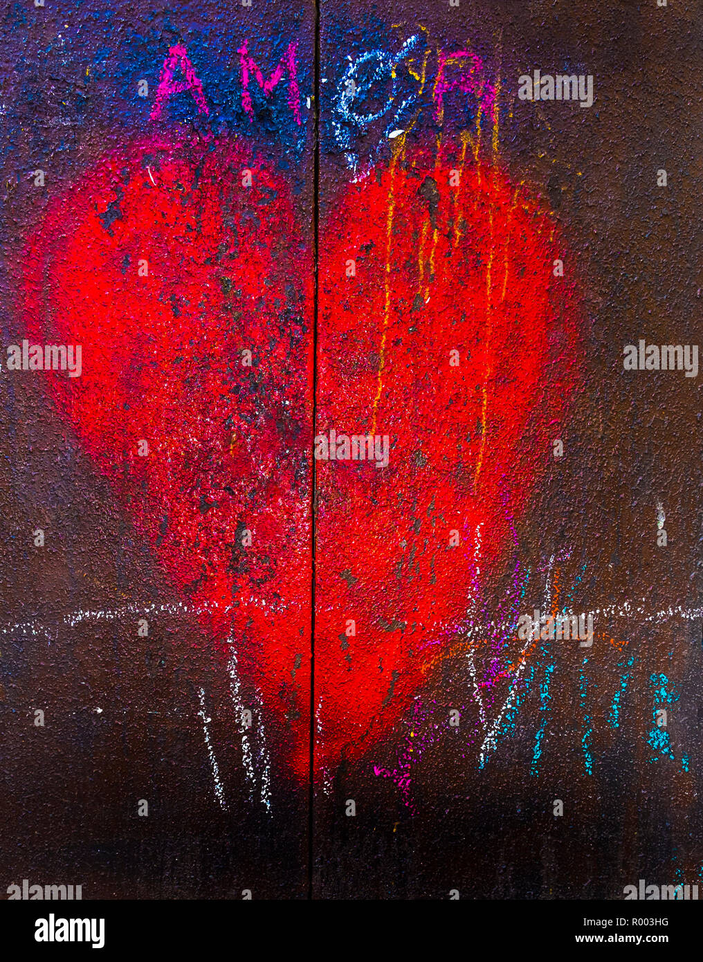red heart on a rusty metal door and the wor: 'amor' Stock Photo