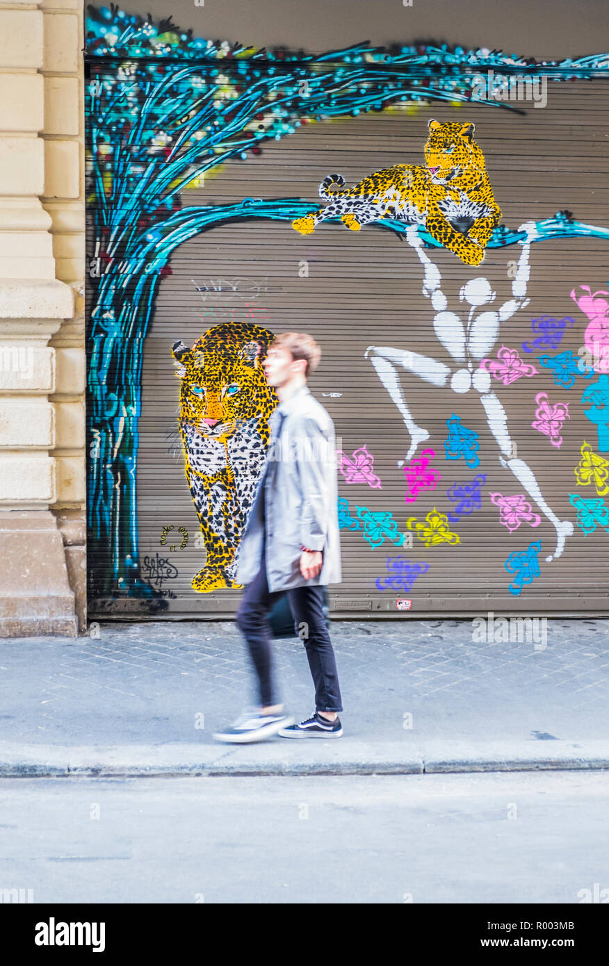 blurred image of young man against grafitti style painted metal door Stock Photo