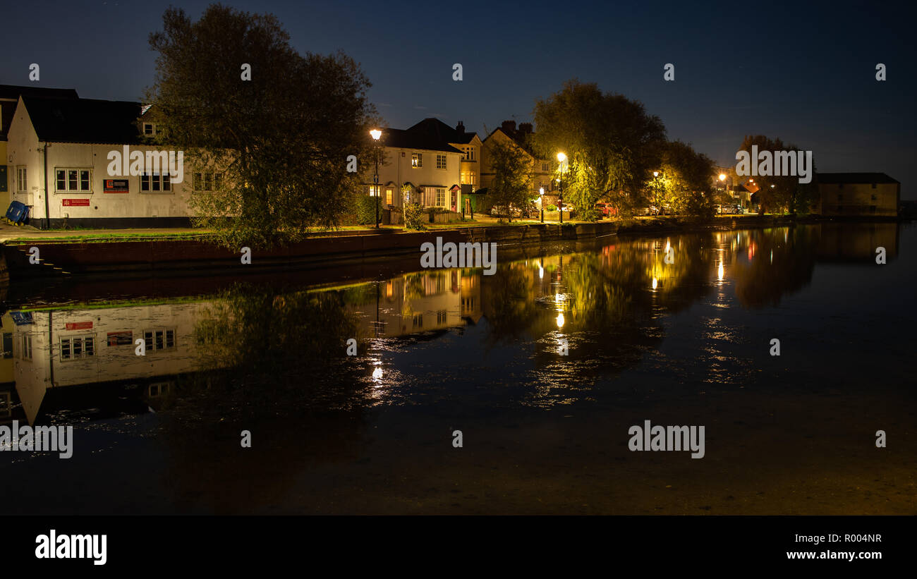 houses at Emsworth Mill pond reflecting on the water at night Stock