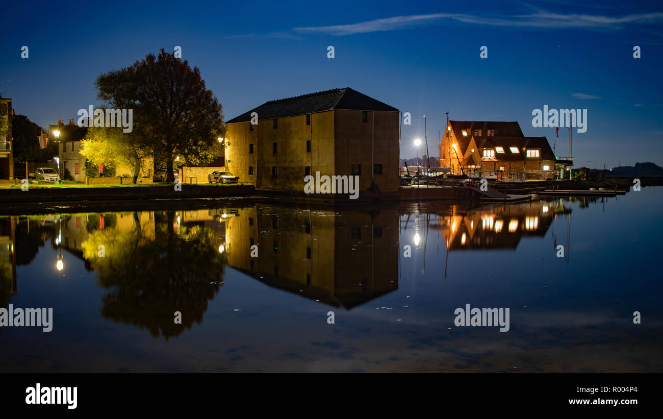 houses at Emsworth Mill pond reflecting on the water at night Stock