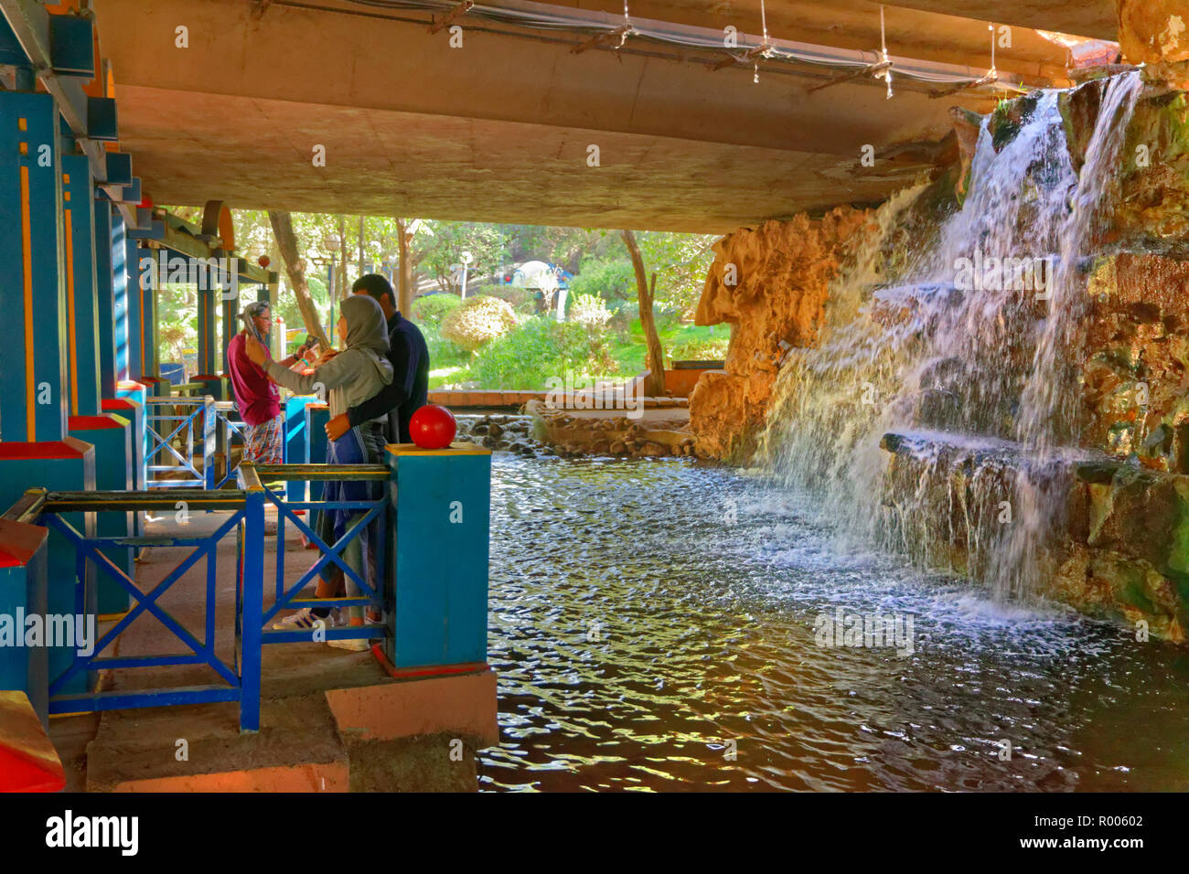Waterfall feature under highway flyover at Bird Valley park, Vallée des Oiseaux, in central Agadir, Souss-Massa Province, Morocco, North West Africa. Stock Photo
