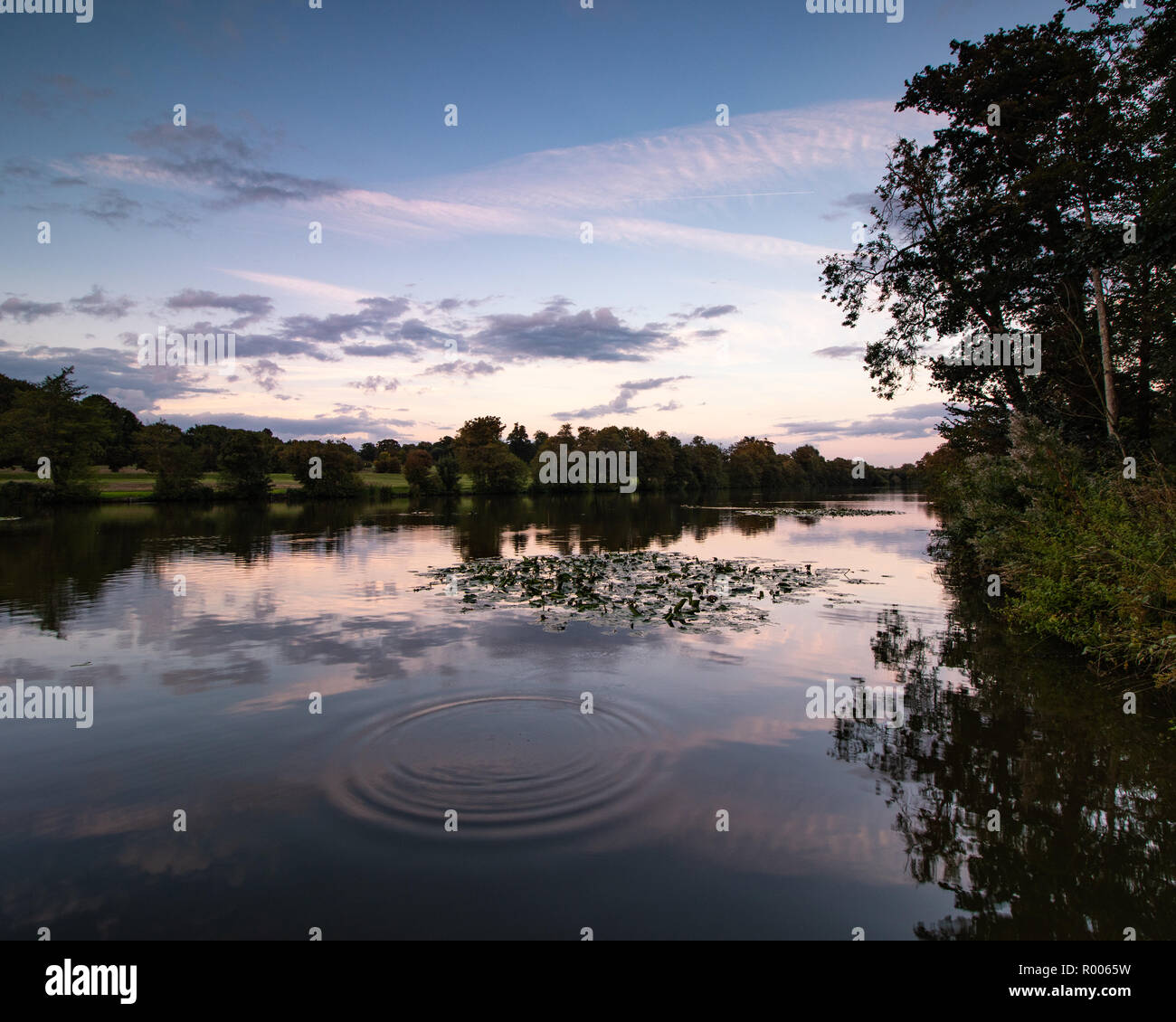 sunset reflections on a calm lake Stock Photo