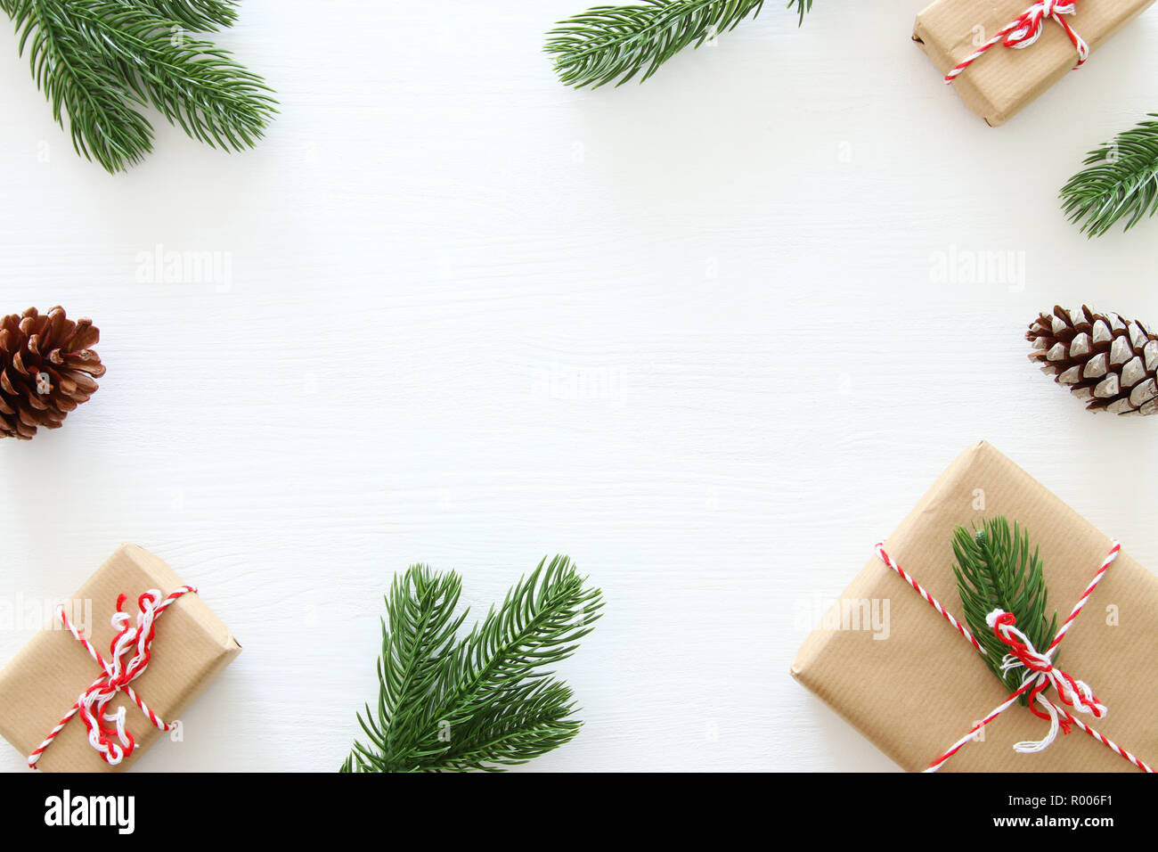Christmas background with pine cones, fir branches and gifts over ...