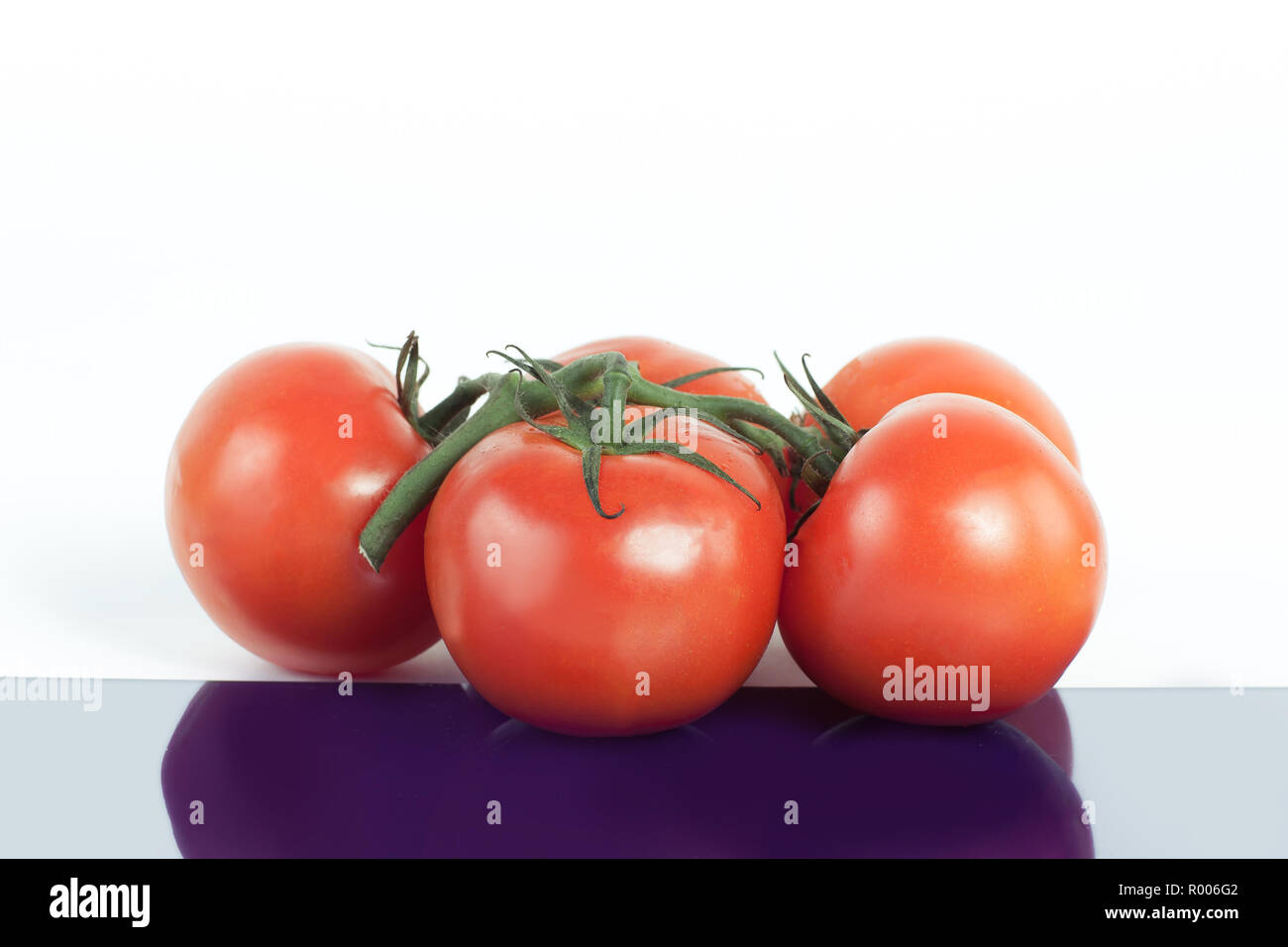 tomatoes on a branch .isolated white background Stock Photo - Alamy