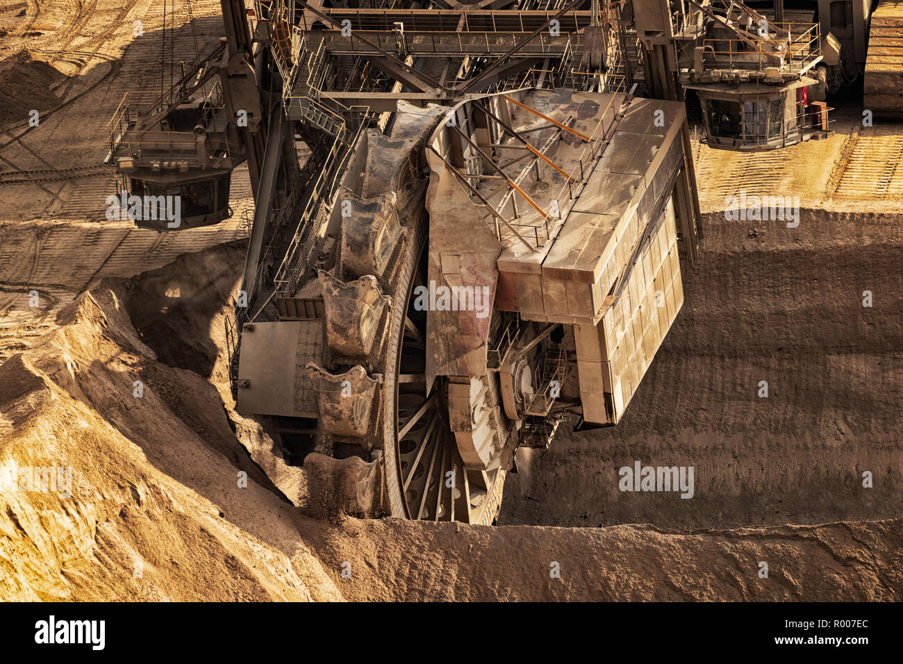 Huge bucket wheel excavator mining for brown coal in an open pit mine. Stock Photo