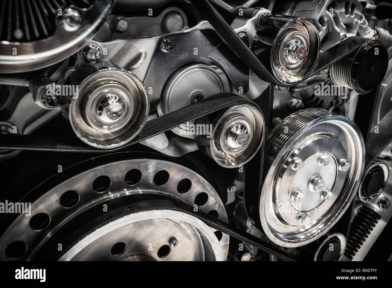 Close up shot of the pulley system and drive belt on a powerful diesel engine. Stock Photo