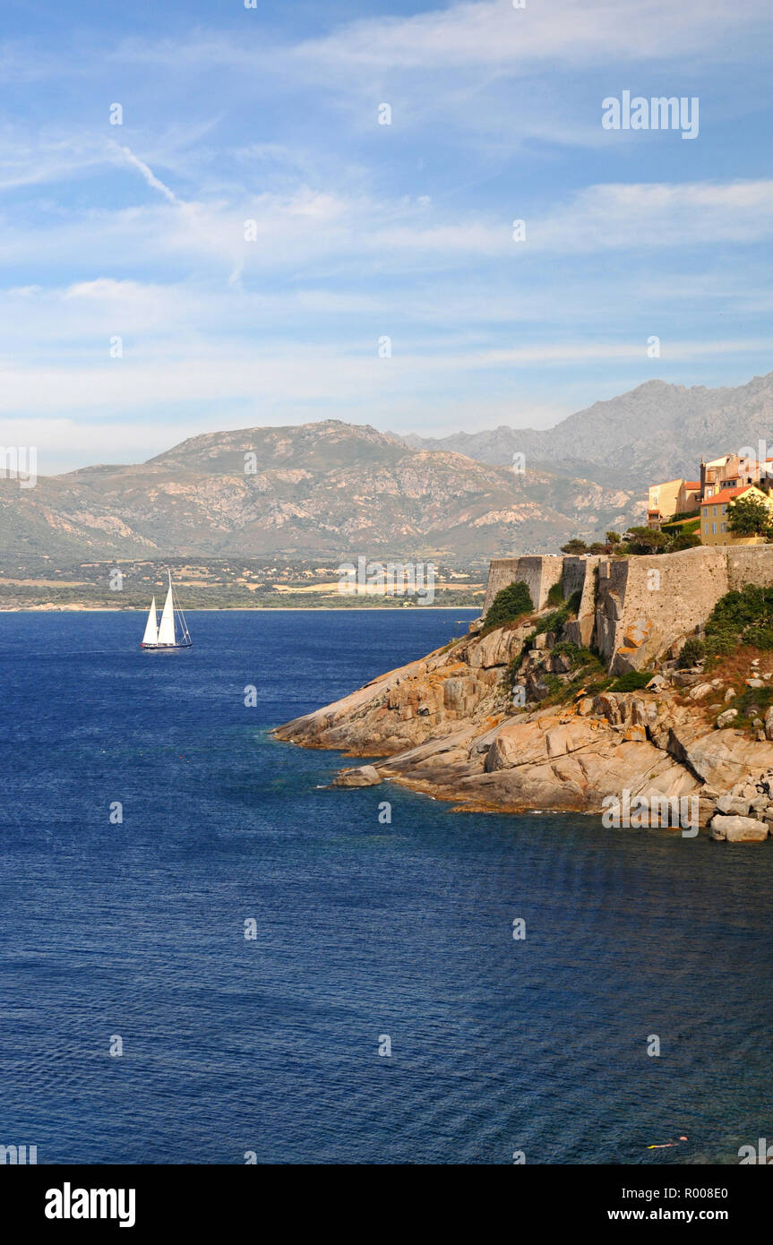 Around Corsica - A private yacht approaching Calvi marina Stock Photo