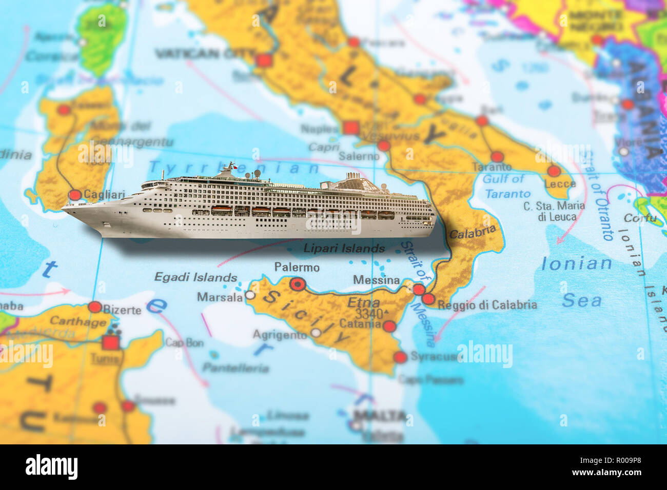 Cruise ship travel on colorful political map of Europe to Italy Islands Sardinia and Sicily in Tyrrhenian sea. Holidays and travel concept. Luxury summer holidays. Stock Photo