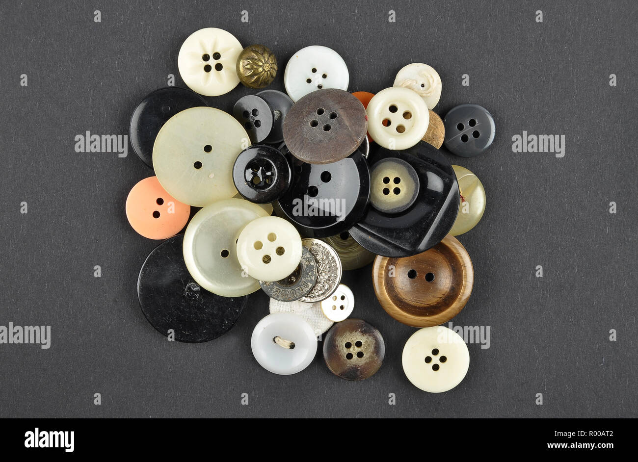 Old buttons on black background Stock Photo - Alamy