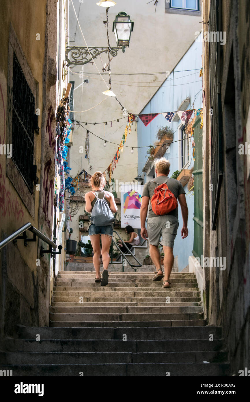 Tourists in the narrow streets of the Alfama district, Lisbon, Portugal. Stock Photo