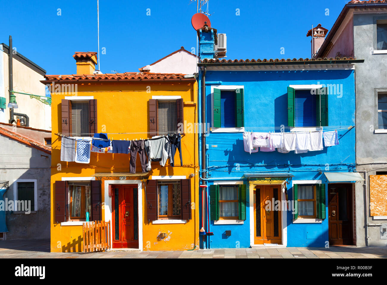 Colourfully painted house facade on Burano island in sunny day,Venice, Italy Stock Photo