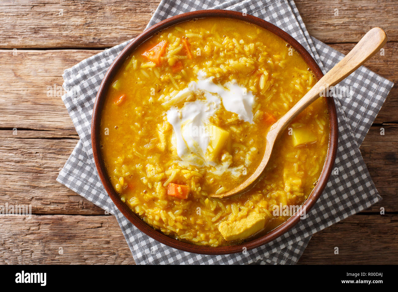 Delicious Tamil Mulligatawny soup with lentils, rice, chicken, vegetables and apple closeup in a bowl on the table. Horizontal top view from above Stock Photo