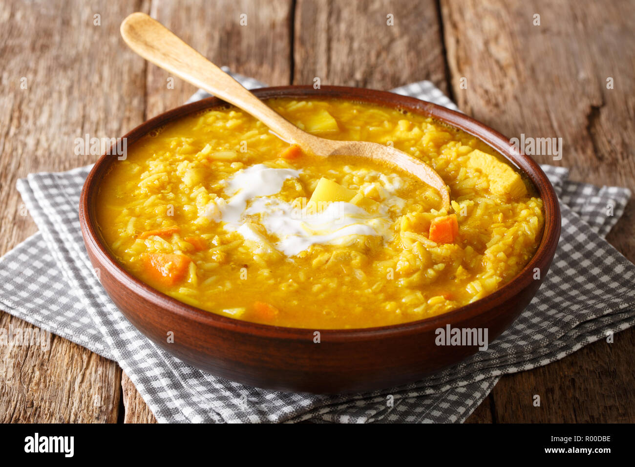 Delicious Tamil Mulligatawny soup with lentils, rice, chicken, vegetables and apple closeup in a bowl on the table. horizontal Stock Photo