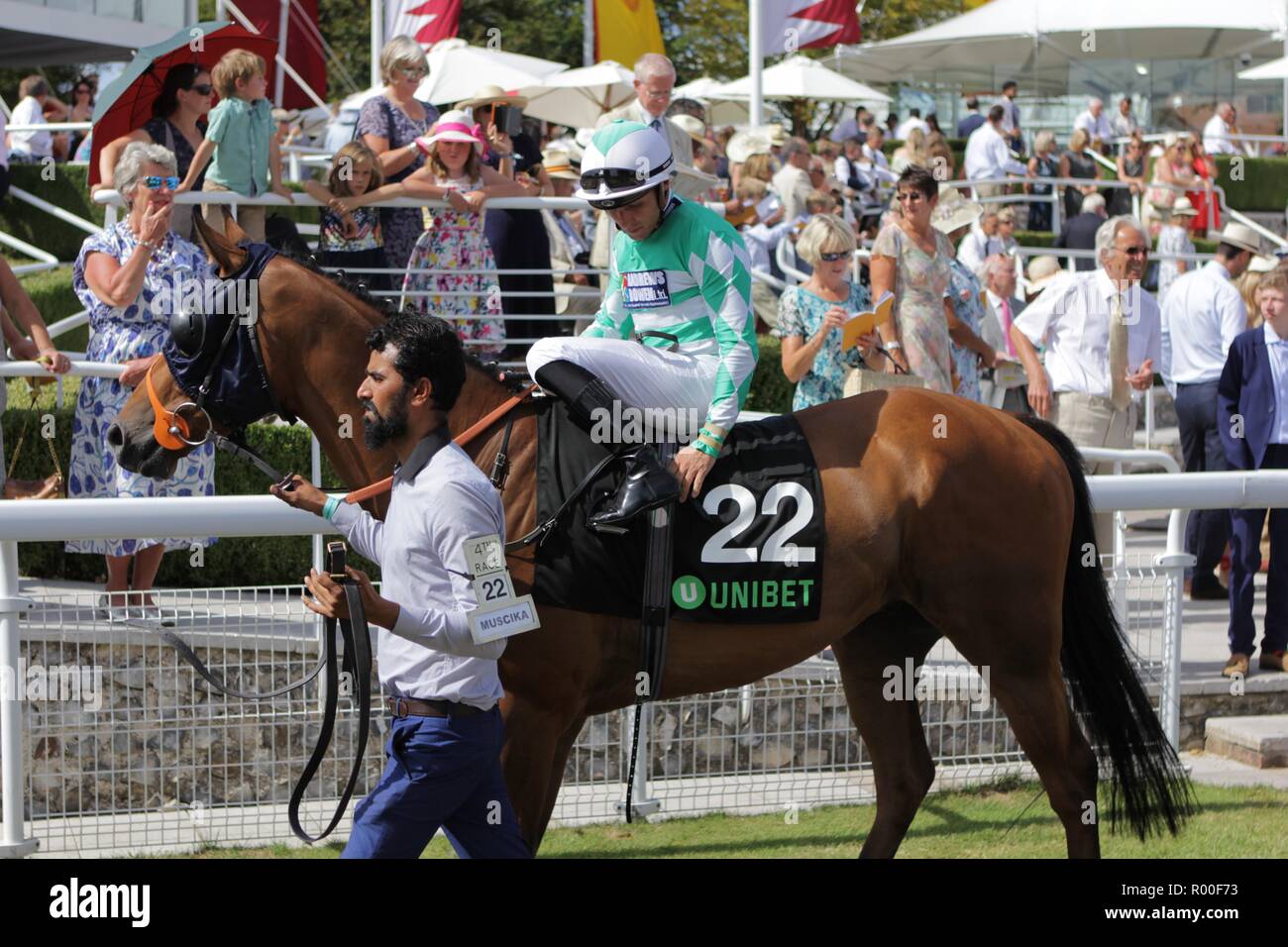 Horse with Jockey and stable hand Stock Photo - Alamy