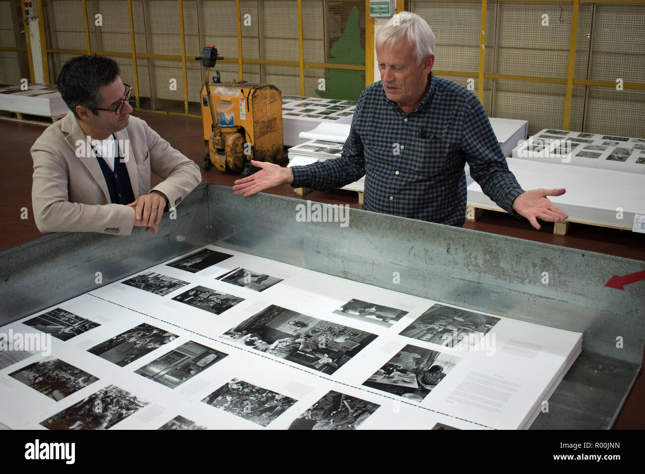 Dewi Lewis British photography book publisher on press publishing My British Archive, The Way We Were 1968-1983 at EBS Verona Italy. Jonathan Bortolazzi MD of EBS looking at page proofs. 2018 HOMER SYKES Stock Photo