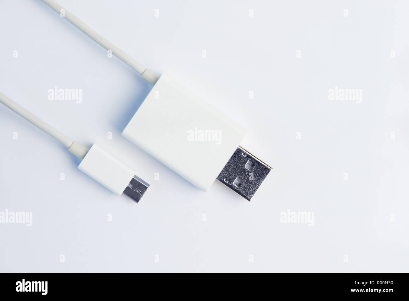 White micro USB cables on white background. Connectors and sockets for PC and mobile devices. Computer peripherals connector or recharge supply. Stock Photo